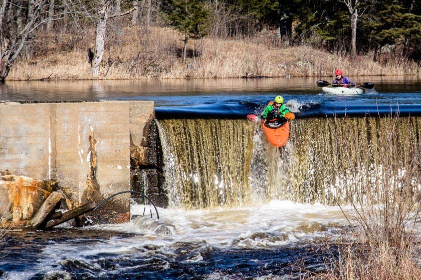 Kayakers going over the dam by Dave deLang